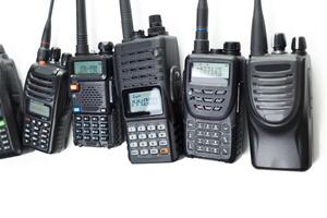 Different types of two-way radios lined up for communication and signaling in various settings photo
