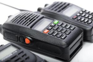 Various models of handheld communication devices on a clean surface for public safety and personal use photo