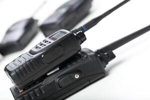 Communication devices stacked on a table in a modern workspace setting for efficient teamwork and coordination photo