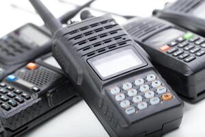Various handheld radios in close-up with a focus on communication technology and devices used for instant connectivity photo