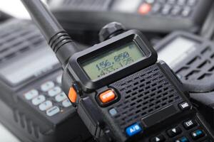 Handheld communication devices displayed on a surface in a professional environment during daylight hours photo