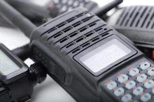Communication devices for emergency services displayed on a white surface in a professional setting photo