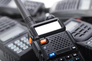 Communication devices stack highlighting handheld radios used for various activities in emergency and outdoor settings photo