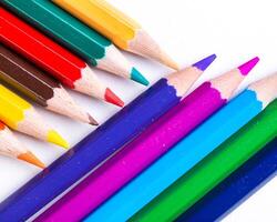Colorful assortment of colored pencils arranged creatively in a vibrant display on a white background photo