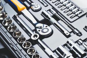 Tool set arranged neatly in a toolbox showcasing various wrenches and sockets for automotive repairs in a workshop setting photo