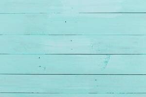 Vibrant turquoise wooden surface with visible grain patterns and slight wear marks photo