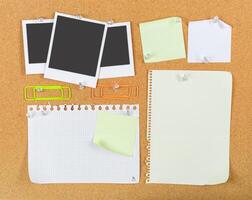 Collection of empty notes and photos pinned on a corkboard at a creative workspace