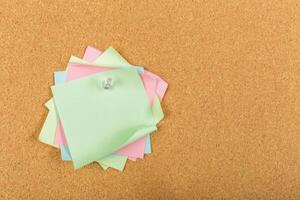 Colorful sticky notes arranged on a corkboard for reminders and organization photo