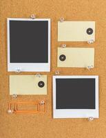 Blank notes and photos pinned on a corkboard displaying creativity and organization in a workspace setting