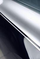 Close-up view of shiny metallic surface reflecting light in a modern indoor space photo