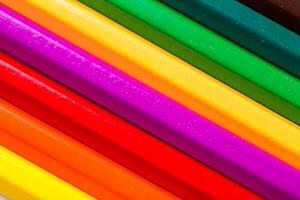 Colorful array of crayons arranged in vibrant stripes on a flat surface showcasing creativity and artistic expression photo