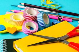 Crafting supplies spread across a colorful workspace for creative projects and DIY activities photo
