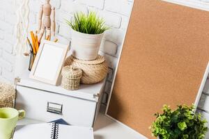 Minimalist workspace featuring greenery and organizational tools in a cozy setting photo
