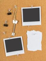 Corkboard displays empty photo frames, a key, and notes suggesting planning and organization in a creative workspace