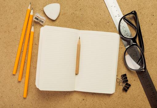 Writing tools and materials arranged on a workspace with a blank notebook and instruments for creativity photo