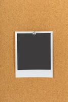 Blank photo frame pinned to cork board ready for personalization in a creative workspace