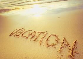 Written message about vacation on sandy beach during sunset, capturing a moment of relaxation and joy photo