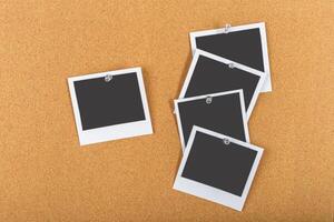 Collection of empty photo frames pinned on a corkboard ready for memories to be captured and displayed creatively