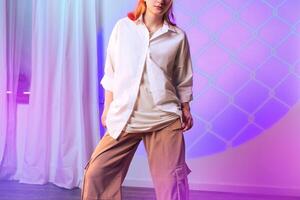 Stylish fashion model showcases contemporary clothing in a modern studio with soft lighting during a creative photoshoot photo
