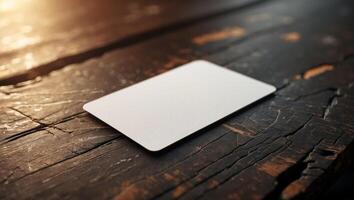 Blank card resting on a textured wooden surface illuminated by soft light in a cozy setting photo