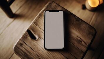 Smartphone resting on rustic wooden table in warm lighting creates a cozy atmosphere for relaxation photo