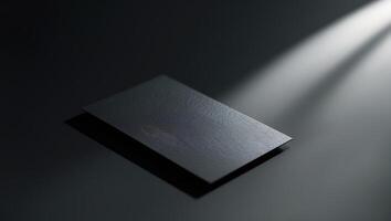 Sleek black business card illuminated by soft light in a minimalistic setting photo