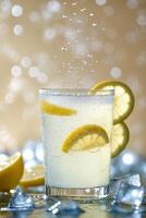 Refreshing lemonade drink with lemon slices and ice in a shimmering background at a summer gathering photo