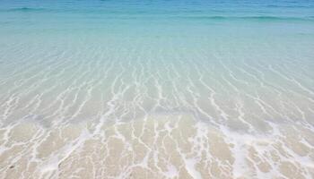 A beach with clear water and white sand photo