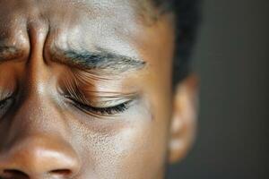 A close up of a man's face with his eyes closed photo