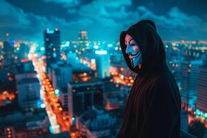 Anonymous hacker in hoodie on cityscape at night photo