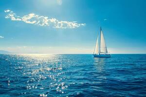 A sailboat floating in the ocean with a bright sun photo
