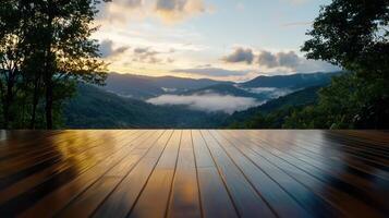 Dawn breaks over a serene mountain landscape, with mist hovering in the valleys. A polished wooden deck provides a perfect viewpoint for appreciating nature's colors and tranquility photo