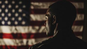 A silhouette of a man in front of an american flag photo