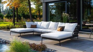 A large white sectional sofa is placed in front of a large window photo