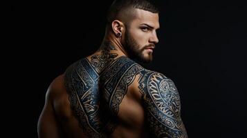 A man with tattoos on his back photo