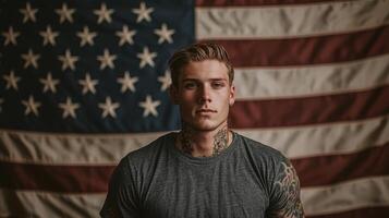 A man with tattoos standing in front of an american flag photo