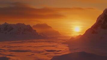 A stunning sunset casts warm orange hues over rugged mountains and expansive snowfields. The serene atmosphere highlights the beauty of a remote winter terrain photo