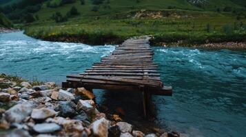Wooden bridge over a river in the mountains photo