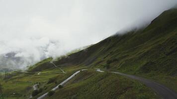 Russia, Caucasus. Shooting from a quadrocopter, a beautiful view of a mountainous valley, overgrown with dense grass, with a well-developed infrastructure photo