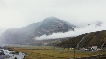 View of the mountain valley from quadcopter. Foot of hilly mountains and cliffs photo