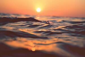 The sun is setting over the ocean in the background photo