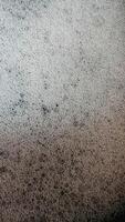 a close up of a black surface with white spots photo