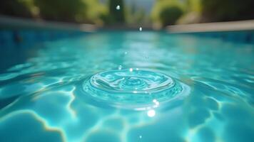 The ripple effect of a drop in a clear pool photo