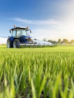 A tractor is working in a green field photo