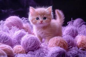 Cute baby kitten exploring a colorful world of soft yarn balls photo