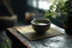Steaming matcha tea in traditional japanese bowl on rustic wooden table photo