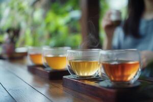 Steaming teacups sitting on wooden table in traditional tea ceremony photo