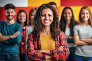 Young woman smiling with folded arms and diverse group of students in background photo