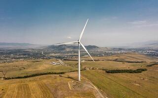 Aerial view of wind turbine rotating and generating energy photo
