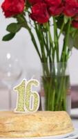 16 years birthday candle in cake form of the number 16, inserted into the holiday cake, is lit. Celebrating a birthday or a landmark event. The climax of the celebration. video